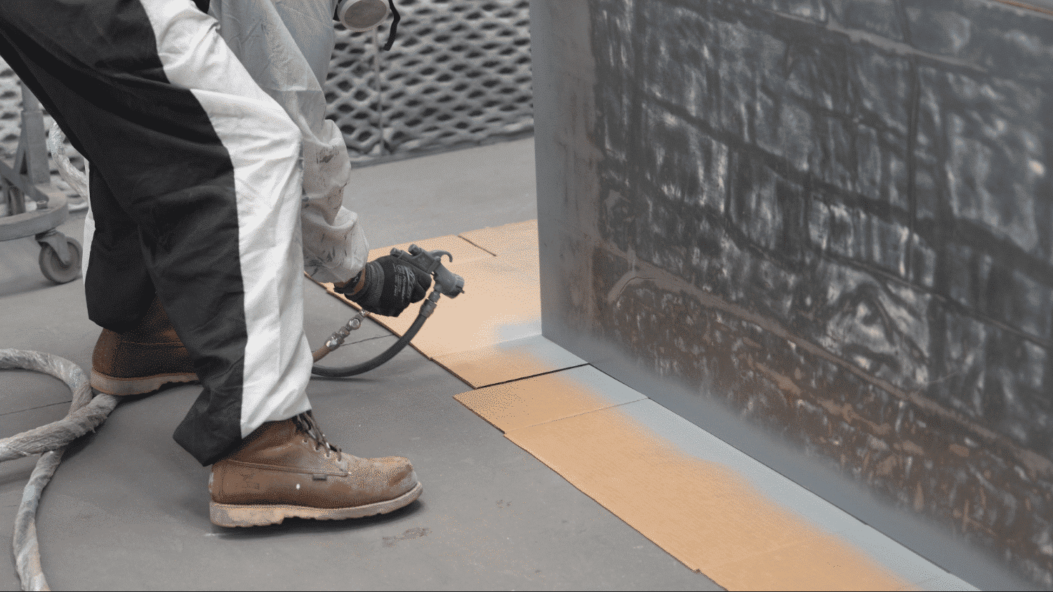 Base painting bottom edge specialist painting the bottom of a structure in ppe