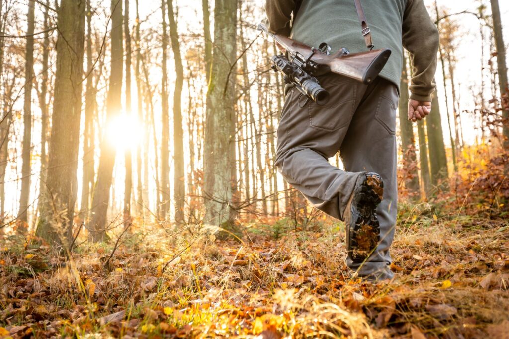 HuntingImage Man Hunting with Rifle in the woods
