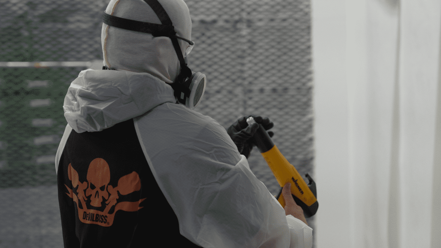 WarrantyRepairPaintandPowder A worker in devilbiss ppe looking at a wagner paint gun